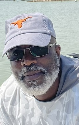 James Ghent, author of A Spring to Remember, wearing a Texas Longhorns cap on the water